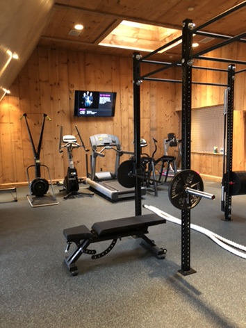 Sands Point residence gym with strength equipment and open training area
